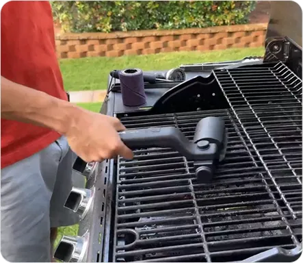 GrillSync Electric Brush cleaning a grill grate